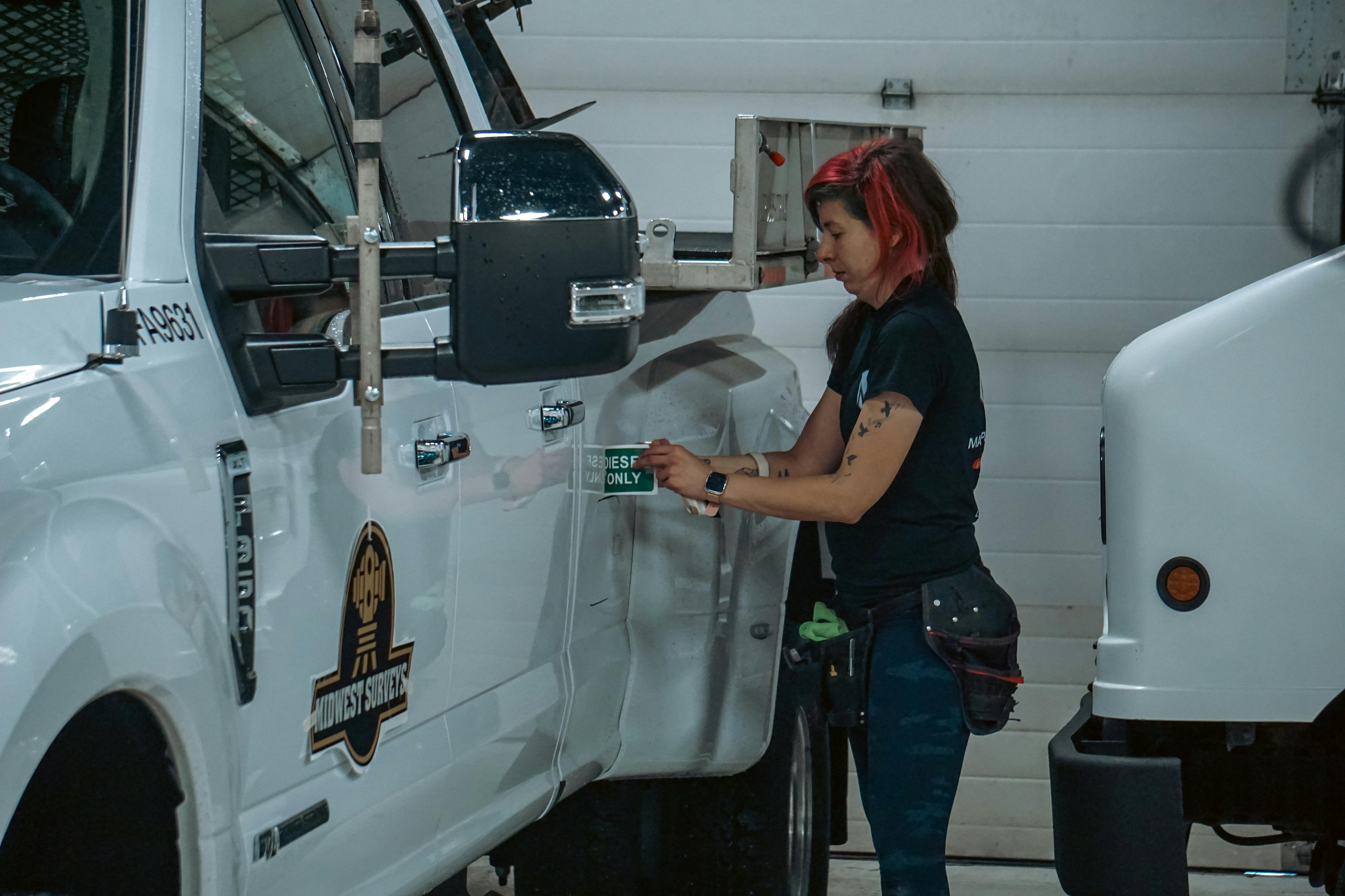 Fleet maintenance supervisor inspecting a vehicle in the maintenance yard