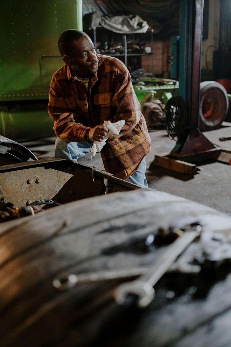 School bus maintenance technician working on fleet equipment in the shop